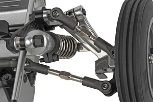 Close-up view of the front suspension, shock absorber, steering links, and wheel on a 1/10 scale RC buggy.