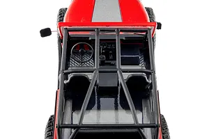 Top-down view of the interior and roll cage of the Axial SCX30 Jeep RC rock crawler in red.