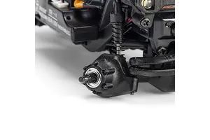 Close-up of the front axle, coil-over shock, and wheel hub assembly of an Axial RC rock crawler against a white background.