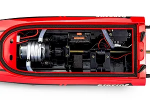 Top-down view of the interior hull of the Atrek Riptide 16 RC speed boat, showing the motor, cooling lines, steering servo, and wiring.