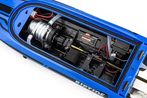Top-down view of the internal components inside the blue hull of the Atrek Riptide RC boat, showing motor, wiring, and servo.