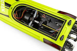 Top-down view of the open interior hull of the Atrek Rogue 22 inch green brushless RC speed boat showing the motor, wiring, and drive shaft.