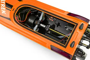 Top-down view of the open hull interior of the Atrek Rogue orange RC speed boat showing motor, wiring, and shaft.