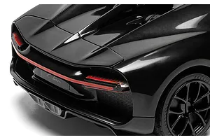 Close-up rear view of a black Bugatti Chiron model car showing taillights, rear spoiler, and wheel.