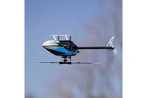 Side view of the Blade Revolution 155 CP RC helicopter in flight against a clear blue sky backdrop.