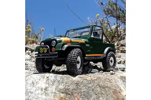 Axial SCX30 Jeep CJ-7 Renegade green RC rock crawler driving outdoors on rocky ground under a blue sky.
