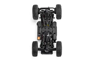 Bottom-up studio view of the chassis, axles, suspension links, and tires of the Axial SCX30 RC rock crawler.