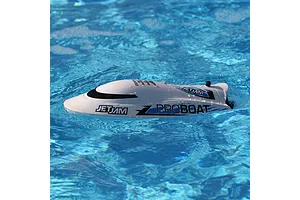 Pro Boat Jet Jam V2 electric RC speed boat floating in bright blue swimming pool water during action shot.