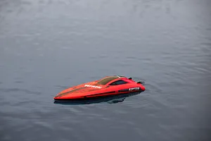 Atrek Riptide red RC speed boat floating on calm water outdoors