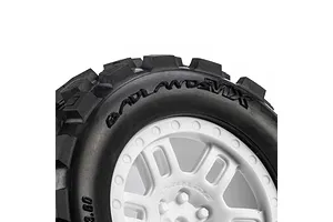 Close-up of Pro-Line Badlands MX tyre on a white split-six rim against a plain white background.