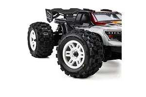 Pro-Line Badlands MX MT tyres mounted on white split six rims installed on an RC monster truck.