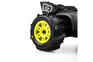 Pro-Line Dumont paddle tyre mounted on a yellow split-six wheel installed on an RC car against a white background.
