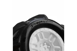 Close-up detail of Pro-Line Dumont paddle tyre mounted on a white split-six rim against a plain background.