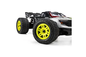 Pro-Line Menace street tyres mounted on yellow split-six rims installed on an RC truck against a white background