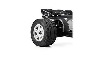 Close-up of a Pro-Line Menace street tyre mounted on a white split-six rim installed on an RC car against a white background.