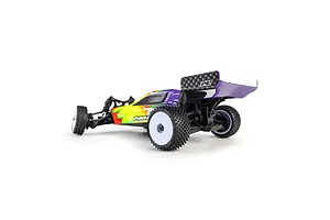Pro-Line 1/24 scale RC buggy installed with patterned carpet tyres and white rims, viewed from the rear three-quarters.