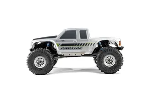 Side view of a silver RC crawler truck featuring Pro-Line Chisel II tyres mounted on beadlock wheels against a white background.