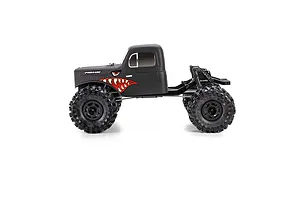Pro-Line matte black cab-only crawler body installed on an RC chassis with large off-road tires against a white background.