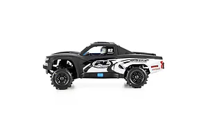 Side view of Pro-Line 1/16 Chevy Silverado Trophy Truck matte black body shell mounted on an RC chassis.