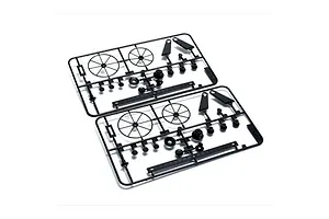 Two identical black plastic parts trees containing wheels, rudders, and small components on a white background.