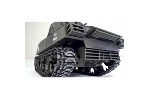 Low angle rear view of the green Taigen RC tank showing detailed tracks and exhaust grilles against a white background.