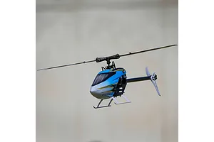 Blade Revolution 155 CP RC helicopter in flight against a neutral indoor background
