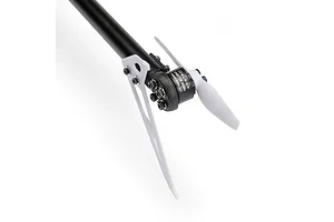 Close-up of an RC helicopter tail rotor assembly featuring a black motor, white blades, and carbon fiber tail boom on a white background.