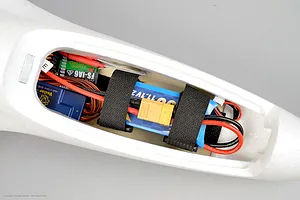Top-down view of the internal electronics bay of the Arrows RC Prodigy trainer plane showing receiver, stabilizer, and battery.