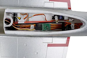 Top-down view of the interior electronics compartment of the Arrows RC P-51 Mustang showing receiver, wiring, servo, and control linkages.