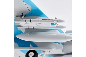 Close-up of the underside of the FMS F/A-18 Hornet RC plane wing, showing mounted missiles, external fuel tank, landing gear, and INTAKE text.
