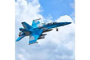 FMS F/A-18 Hornet RC jet airplane flying against a cloudy blue sky background