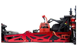 Side view of an ARRMA RC car chassis featuring a red anodized aluminium TVP side plate and a BLX electronic speed controller.