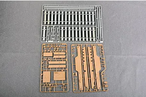 Three plastic model kit sprues for a 1/35 scale military vehicle, including railway track sections and structural parts.