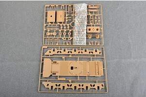 Two plastic model kit sprues for a 1/35 scale military vehicle, featuring tan plastic parts on a grey textured background.