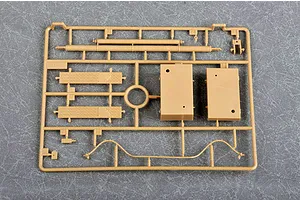 A tan plastic model kit sprue containing various parts for a German Morser Karl self-propelled gun model, set against a grey textured background.