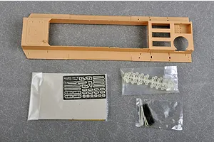 A large tan plastic model chassis part for the Trumpeter 1/35 Morser Karl kit, alongside small bags containing photo-etched parts, clear plastic, and metal springs.