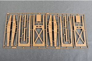 Two identical tan plastic model kit sprues showing structural frame components for a large military vehicle.