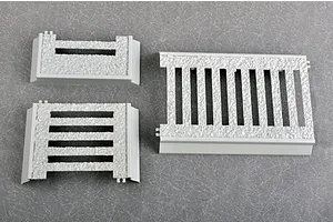 Three grey plastic model kit parts with textured surfaces, likely representing metal grating or flooring for a 1/35 scale military model.