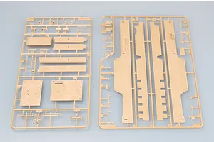 Two tan plastic model kit sprues containing various flat panels and structural components for a military vehicle model.