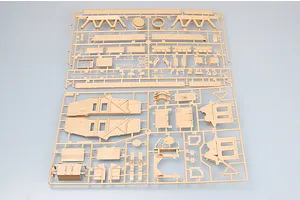Two tan plastic model kit sprues containing various vehicle parts for a 1/35 scale military model.