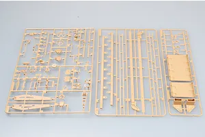 Three tan plastic model kit sprues containing various parts for a military vehicle model, laid out on a light grey background.