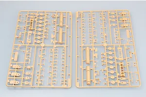 Two tan plastic model kit sprues containing various small parts for a 1/35 scale military vehicle model.