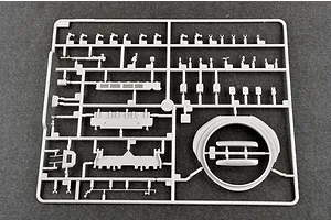 A grey plastic sprue containing various model tank parts, including a turret ring and small components, for a 1/35 scale military model kit.