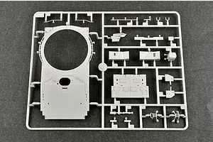 A grey plastic model kit sprue containing parts for a 1/35 scale tank, including a large turret top piece and various smaller components.