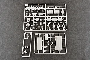 Three grey plastic model kit sprues containing various tank parts laid out on a dark grey surface.