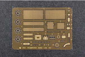 A photo-etched brass fret for a 1/35 scale Trumpeter 2S7 model kit, featuring various mesh screens, circular parts, and small detail components.