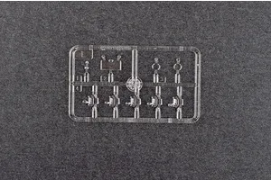 A clear plastic sprue containing small transparent parts for a 1/35 scale model kit, set against a dark grey textured background.