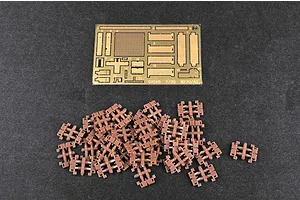 A photo-etched brass fret and a pile of small brown plastic track links for a 1/35 scale model kit.