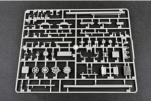 A grey plastic sprue containing various unpainted model kit parts for a 1/35 scale military vehicle, viewed from directly above on a dark background.