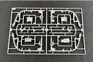 A grey plastic model kit sprue containing various structural and mechanical parts for a 1/35 scale military vehicle model.